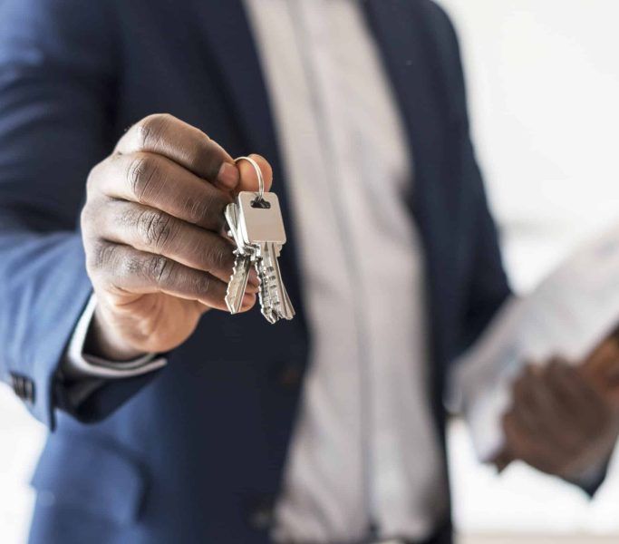 Real estate agent handing the house key